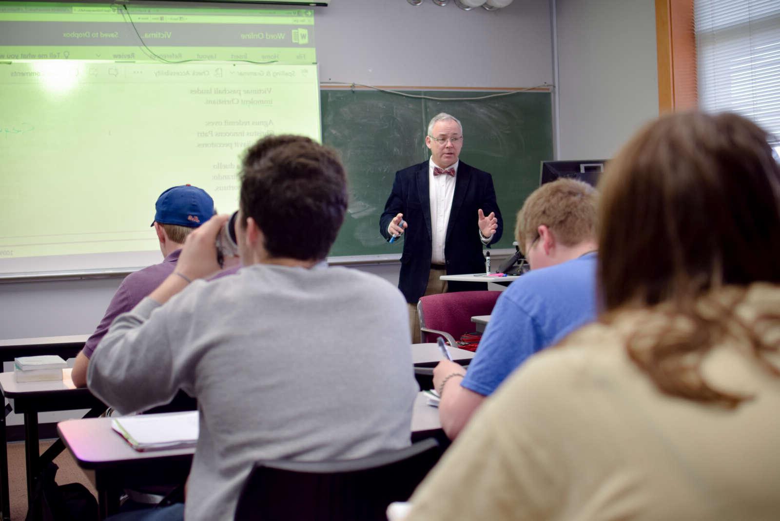 Dr Mulholland teaching with a projector