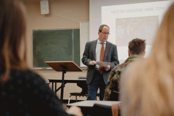 A professor teaches students in a history class